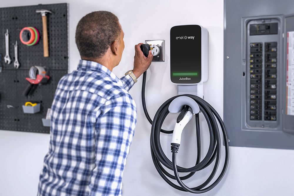 Image of man plugging in a Juicebox EV charger