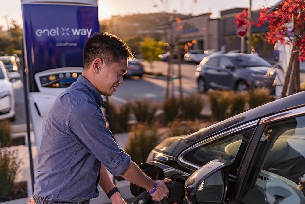 Image of a man charging his EV using an Enel X Way JuicePump