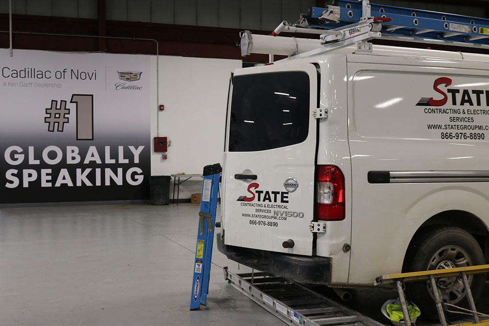 Image of the State Electric Company’s van making EV charging electrical upgrades for the Cadillac of Novi dealership