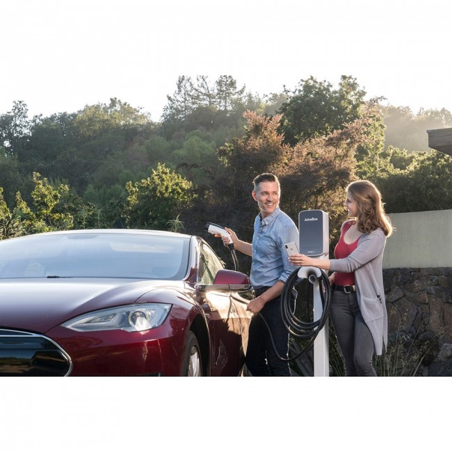 Happy couple charging their EV using the JuiceBox 40 charger