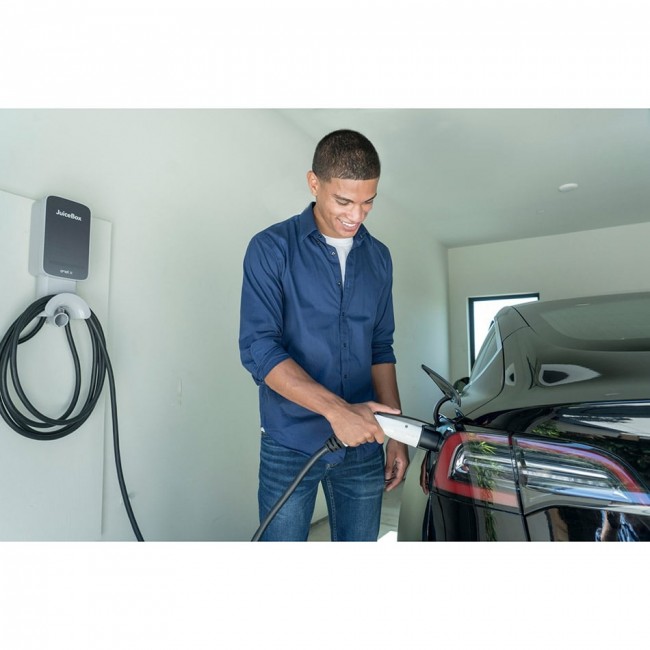 Man charging his vehicle using a JuiceBox 40 EV charger.